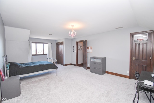 carpeted bedroom featuring a chandelier and lofted ceiling