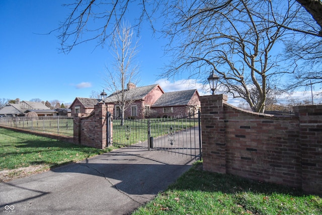 view of gate with a yard