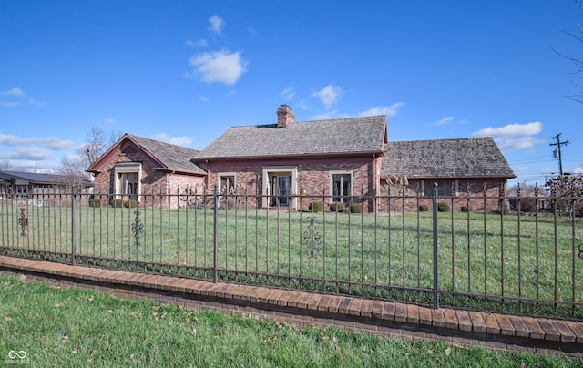 back of house with a lawn