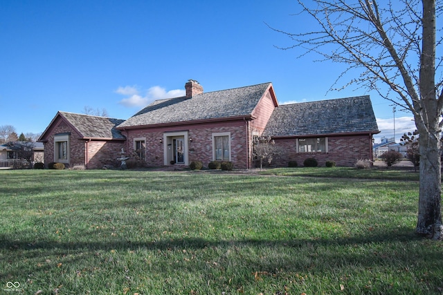 rear view of property featuring a yard