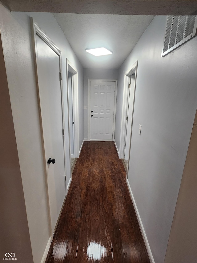 hall with dark hardwood / wood-style floors