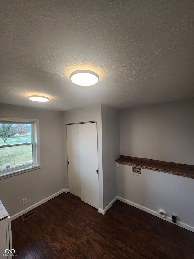 interior space featuring dark hardwood / wood-style flooring and a textured ceiling