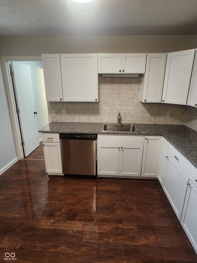 kitchen featuring dark wood-type flooring, white cabinets, sink, stainless steel dishwasher, and a textured ceiling