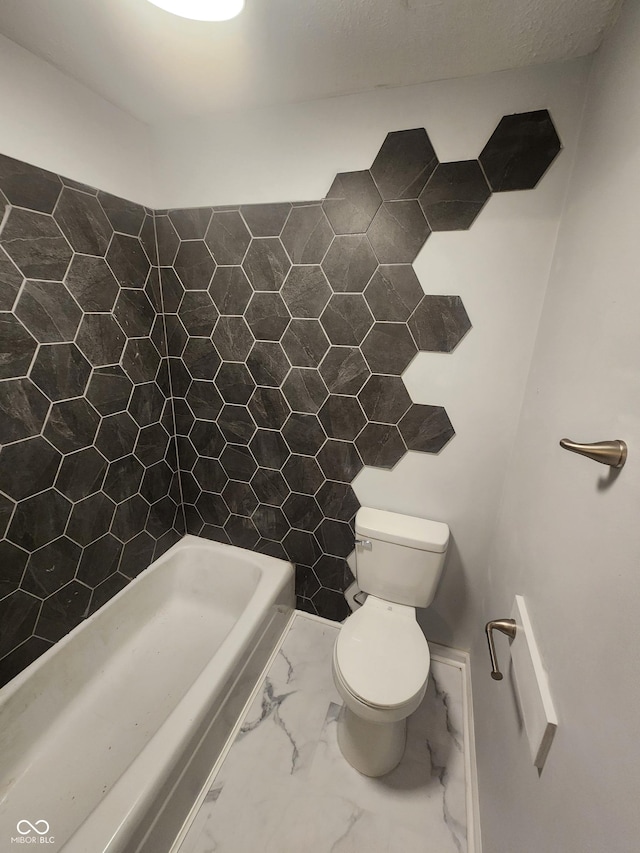 bathroom featuring a tub, tile walls, and toilet