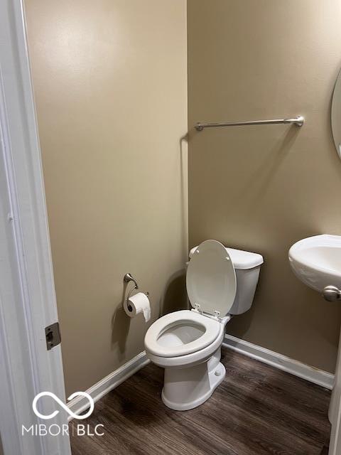 bathroom with wood-type flooring and toilet