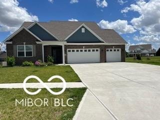 view of front of house with a garage and a front yard