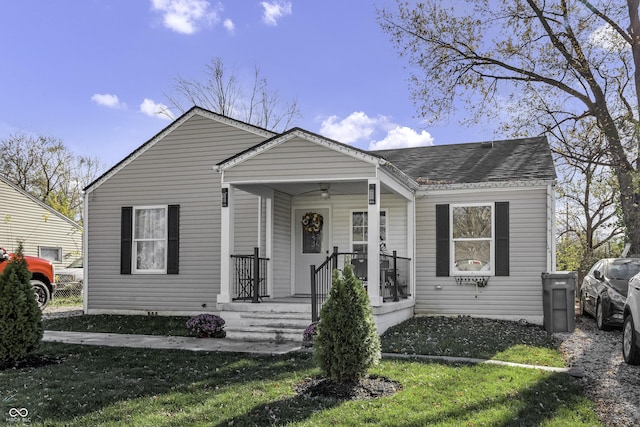 view of front of house featuring covered porch and a front lawn