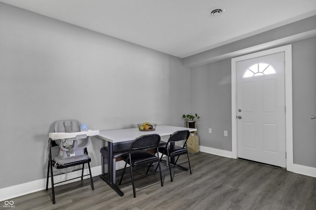 dining space with dark wood-type flooring