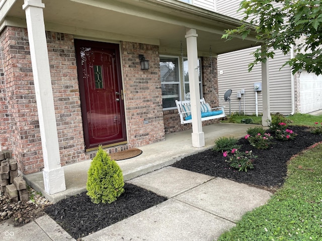 view of exterior entry with covered porch