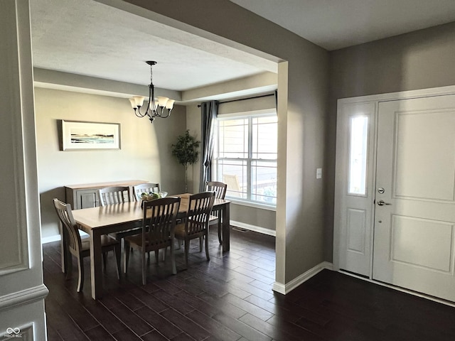 dining area with an inviting chandelier