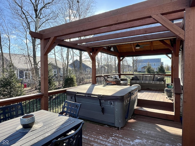 wooden deck with ceiling fan, a hot tub, and an outdoor living space