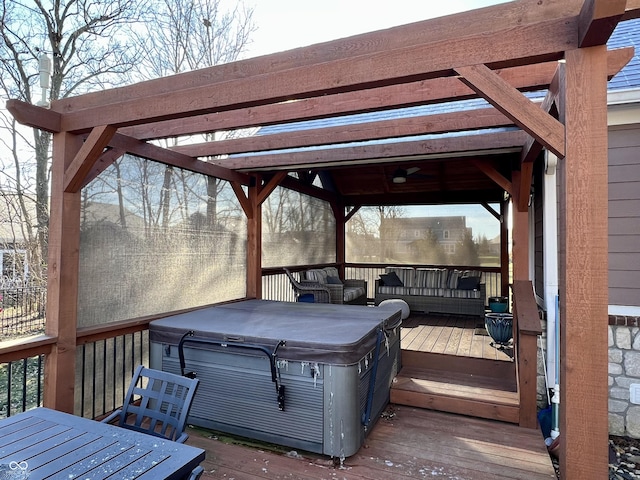 wooden deck featuring a hot tub