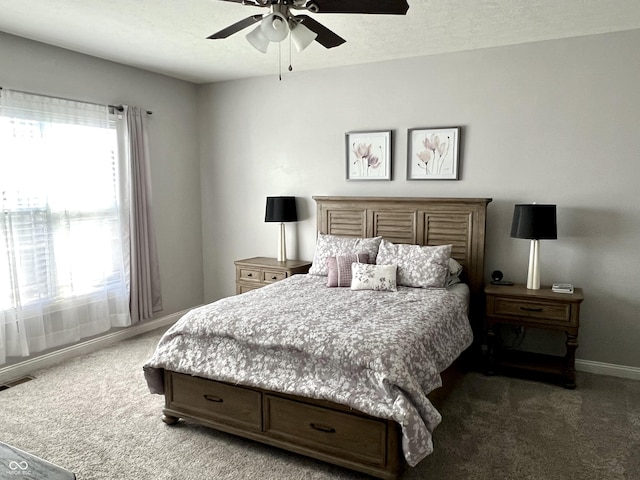 bedroom featuring dark carpet and ceiling fan