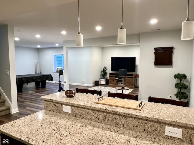 kitchen featuring pendant lighting and light stone countertops