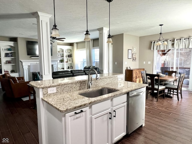 kitchen featuring ceiling fan, sink, stainless steel dishwasher, decorative light fixtures, and white cabinets