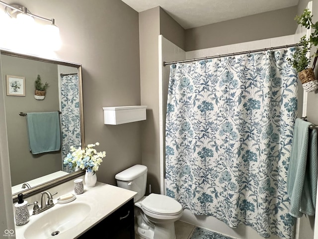 bathroom featuring tile patterned flooring, vanity, toilet, and walk in shower