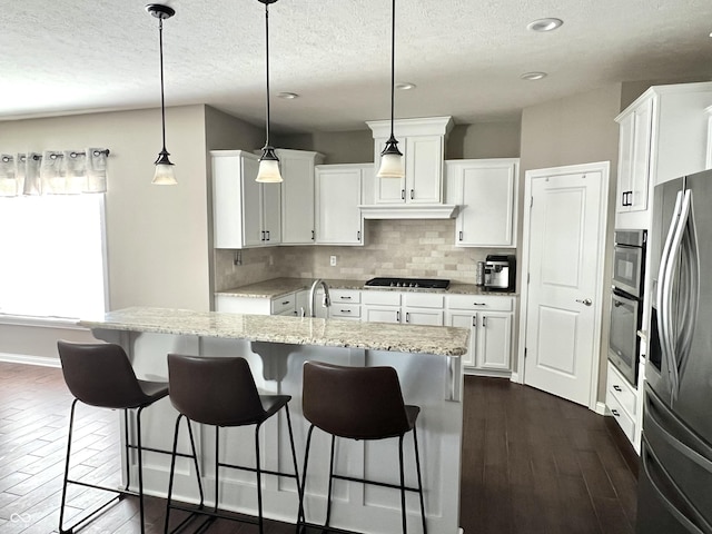 kitchen featuring white cabinetry, dark hardwood / wood-style floors, stainless steel refrigerator with ice dispenser, pendant lighting, and a center island with sink