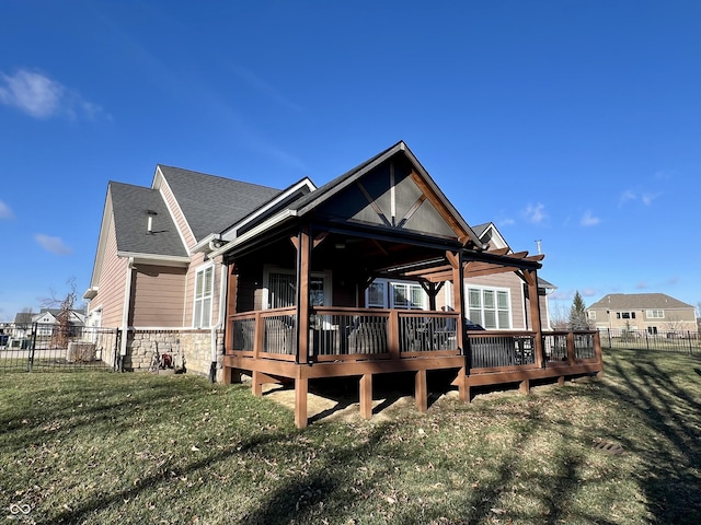 back of property featuring a lawn and a wooden deck