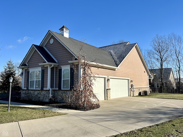 view of side of home featuring a garage and central AC