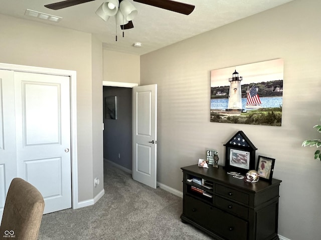 carpeted bedroom with ceiling fan and a closet