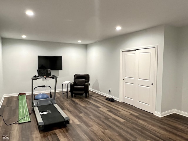 workout area featuring dark wood-type flooring