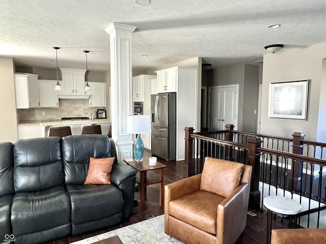 living room featuring dark hardwood / wood-style flooring and a textured ceiling