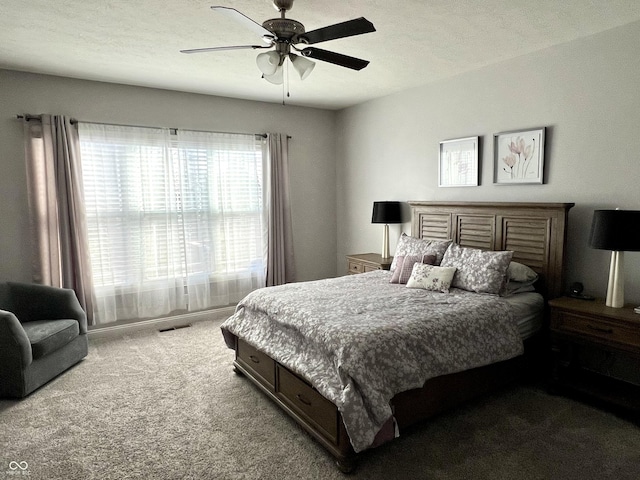 bedroom with carpet, a textured ceiling, and ceiling fan