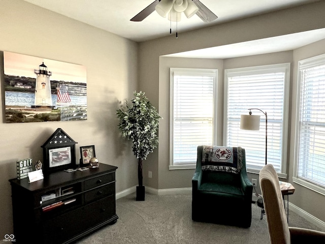 living area featuring carpet floors and ceiling fan