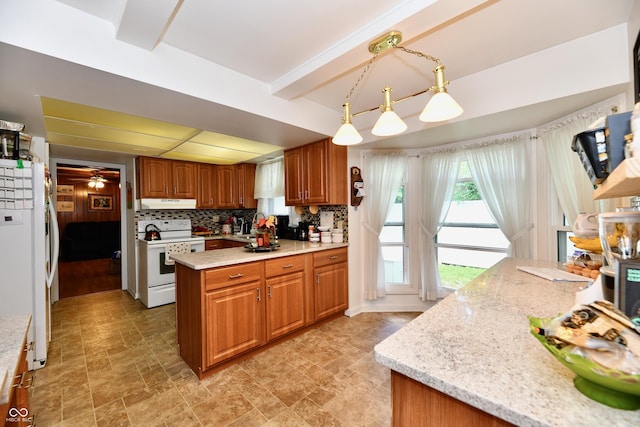 kitchen featuring tasteful backsplash, light stone counters, white appliances, ceiling fan, and pendant lighting