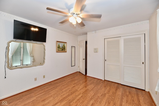 unfurnished bedroom featuring a closet, light hardwood / wood-style flooring, and ceiling fan