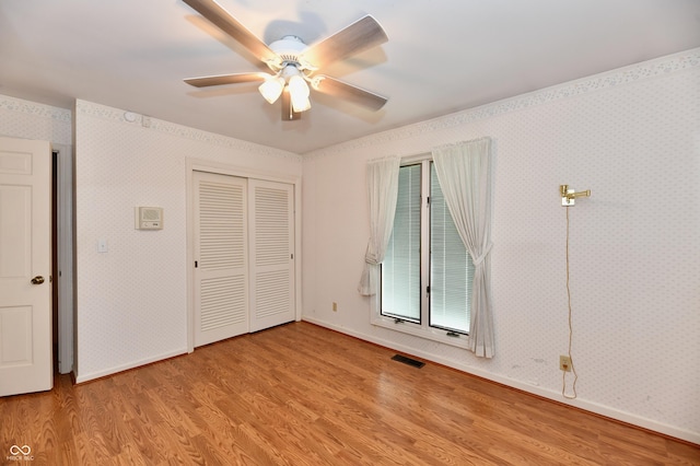 unfurnished bedroom with a closet, ceiling fan, and light hardwood / wood-style flooring