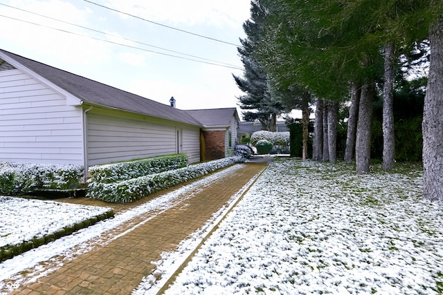 view of yard layered in snow