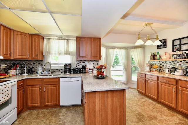 kitchen with backsplash, sink, decorative light fixtures, and white appliances