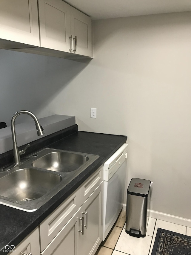 kitchen with sink, white dishwasher, and light tile patterned floors