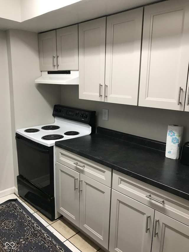 kitchen with white range with electric stovetop and light tile patterned floors