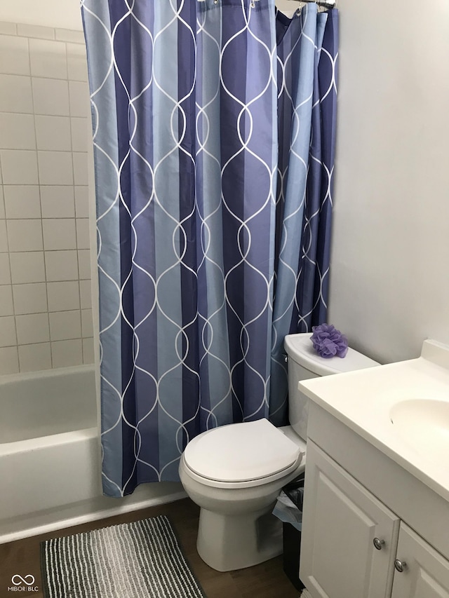 full bathroom with shower / bath combination with curtain, vanity, wood-type flooring, and toilet