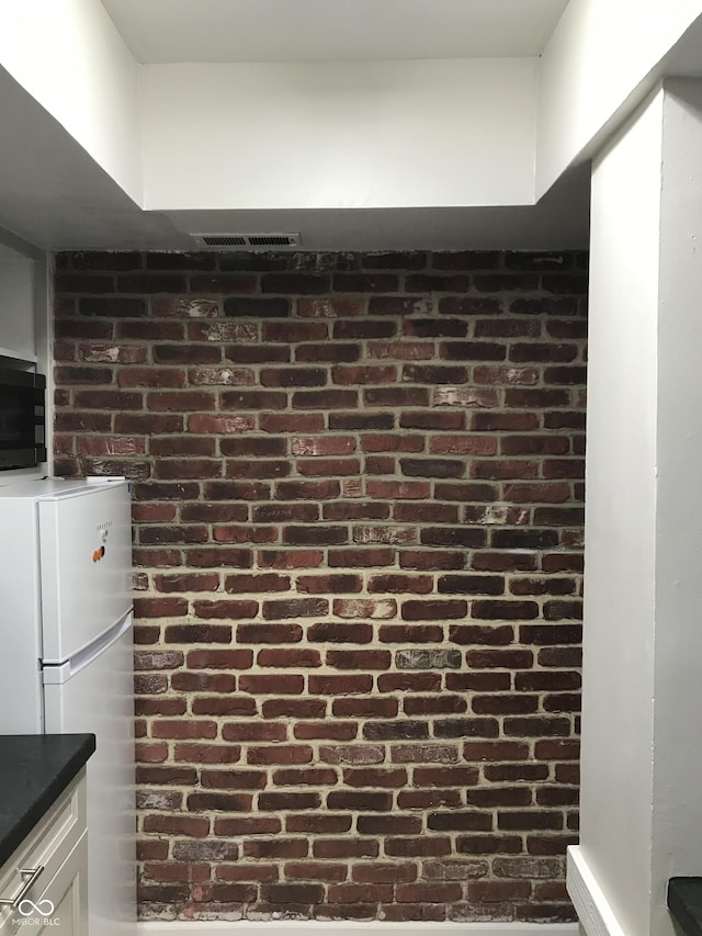 interior details with white cabinets and white refrigerator