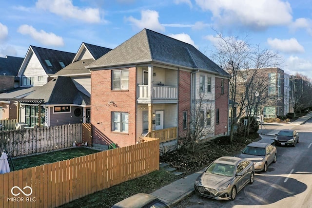 back of house featuring a balcony