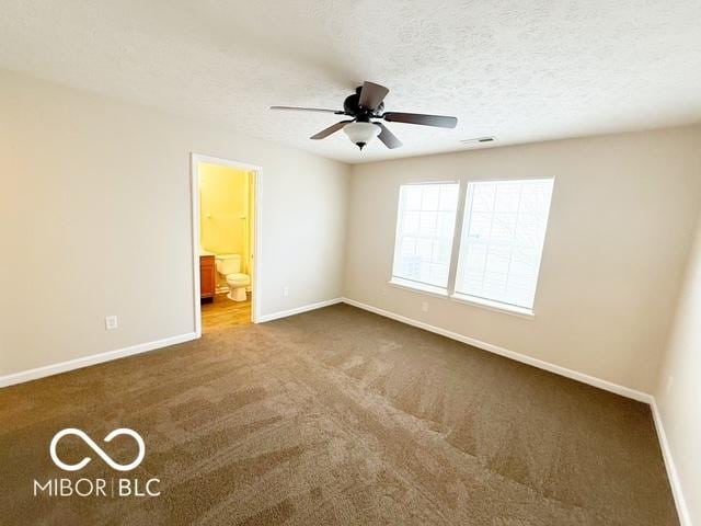 unfurnished bedroom featuring carpet, a textured ceiling, ensuite bath, and ceiling fan