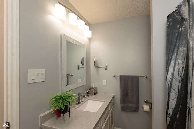 bathroom featuring vanity and a textured ceiling