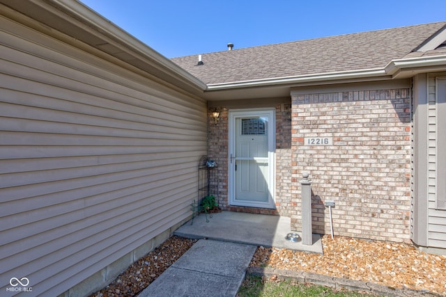 12216 Laurelwood Ct, Indianapolis, IN 46236 - property entrance with brick siding and a shingled roof