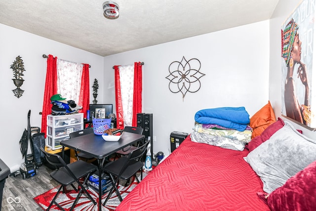 bedroom with hardwood / wood-style flooring and a textured ceiling