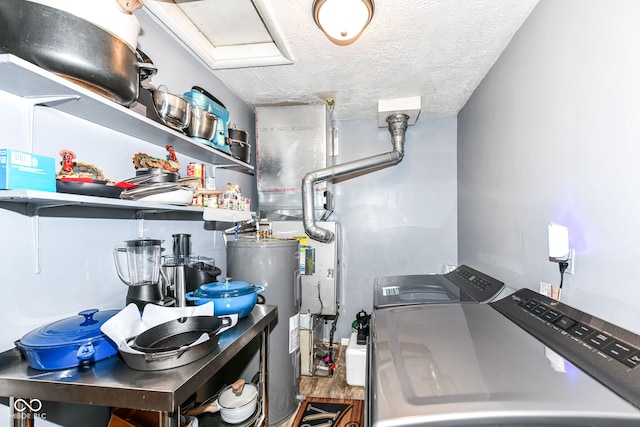 laundry area featuring washer and dryer, a textured ceiling, and water heater