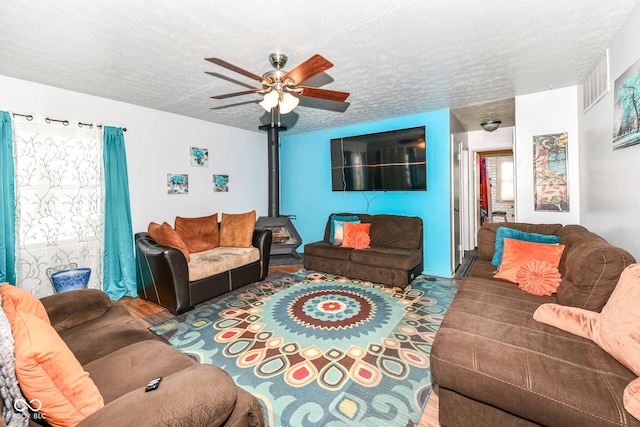 living room featuring a wealth of natural light, a textured ceiling, and ceiling fan