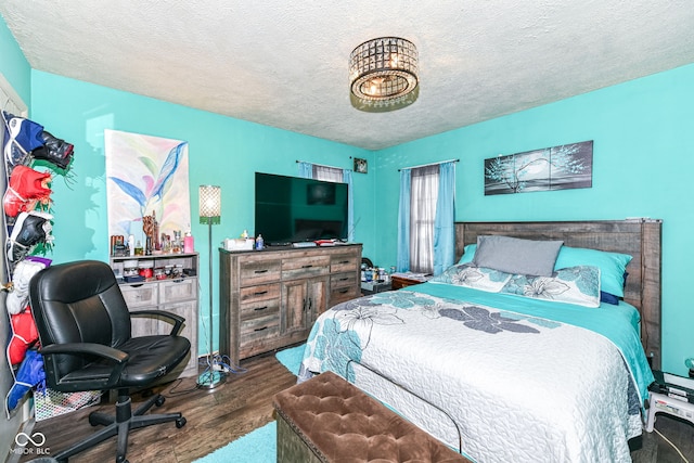 bedroom featuring wood-type flooring and a textured ceiling