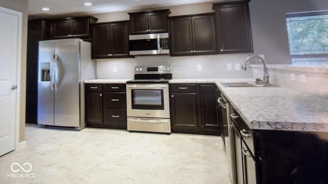 kitchen featuring backsplash, sink, dark brown cabinetry, and stainless steel appliances