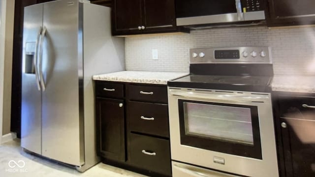 kitchen with appliances with stainless steel finishes, dark brown cabinetry, and backsplash