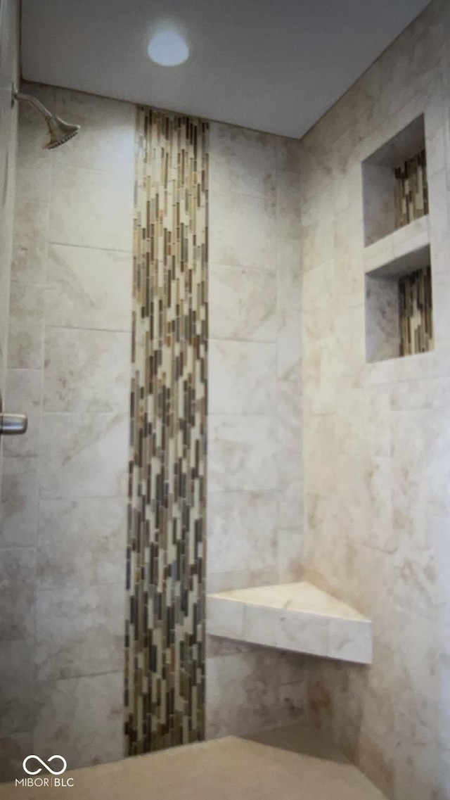 bathroom with tiled shower