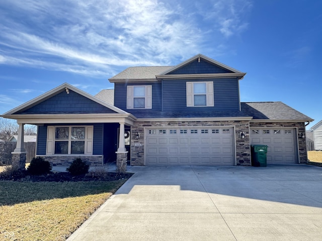 craftsman inspired home featuring stone siding, a shingled roof, concrete driveway, and a front yard