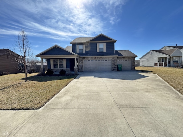 view of front of property featuring an attached garage, stone siding, concrete driveway, and a front yard